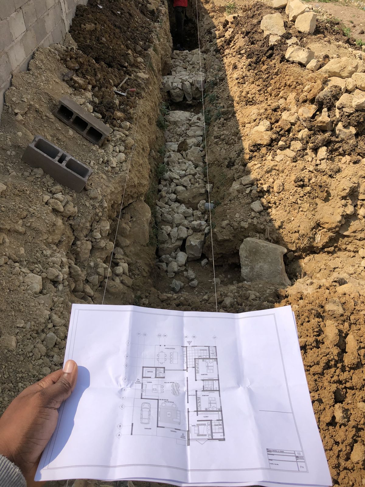 Excavated foundation trench prepared for building works, with floor plans.